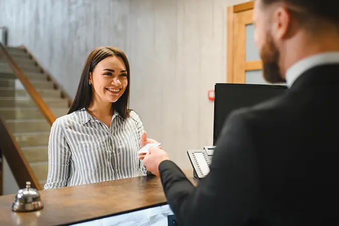 Hotel receptionist with a client