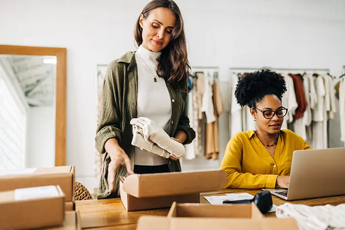 Two business owners packing merchandise